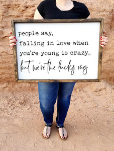 People say falling in love when you're young is crazy. but we're the lucky ones framed wood sign | Wall decor | Above over the bed wall art