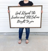 Load image into Gallery viewer, God blessed the broken road that led me straight to you framed Wood Sign Country Song Lyric Wall Decor above over the bed wall art